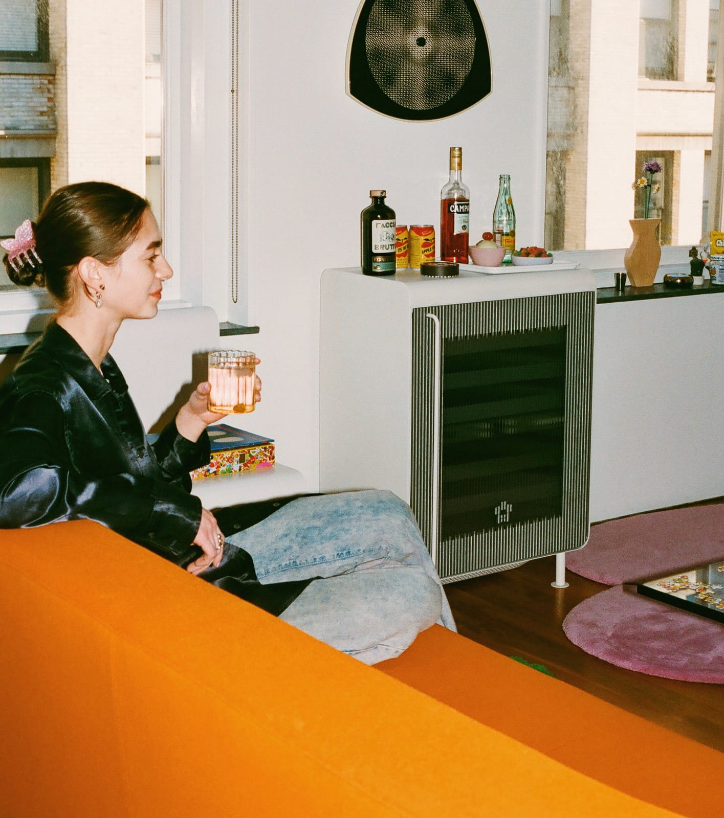 Enjoying a drink next to the Rocco Fridge in white.