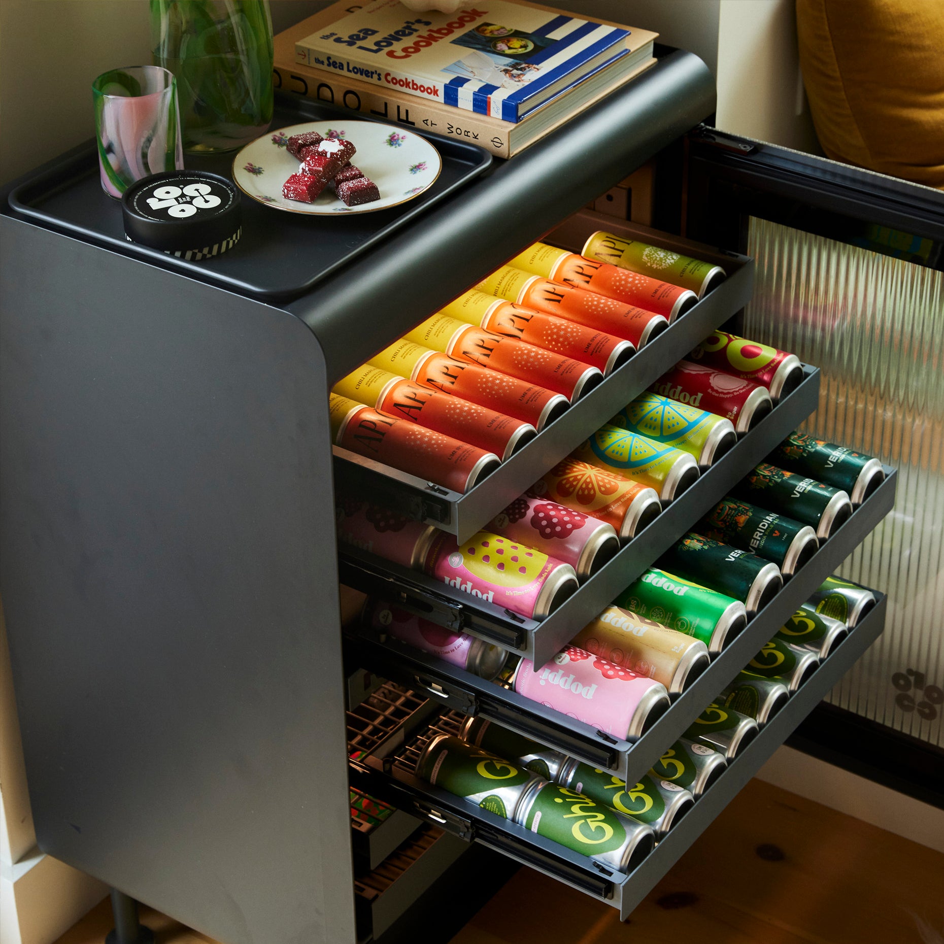 Opened Graphite Rocco fridge filled with different can sizes. 