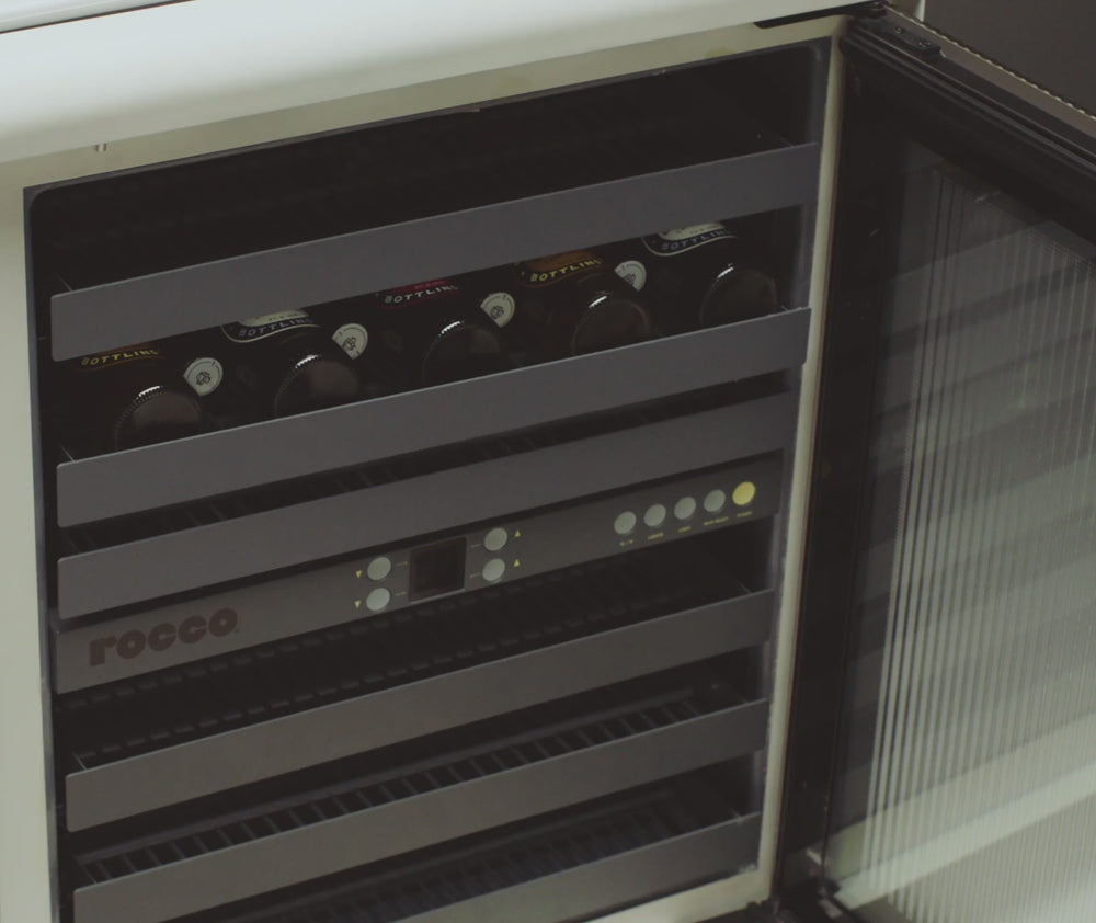Showing the reversible racks in a Rocco Fridge holding different beverages.